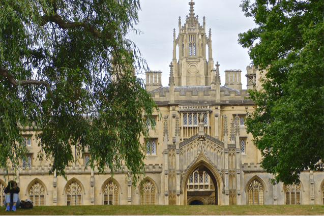 A cathedral on the banks of the River Cam which is seem while punting.