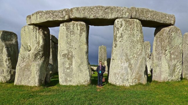 Stonehenge in the early morning with me standing by the stones.