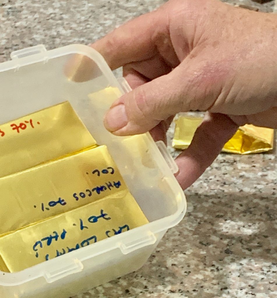 Chocolate is hand folded into paper and labeled