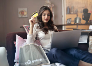 Girl waving her credit card around without concern for safe travels