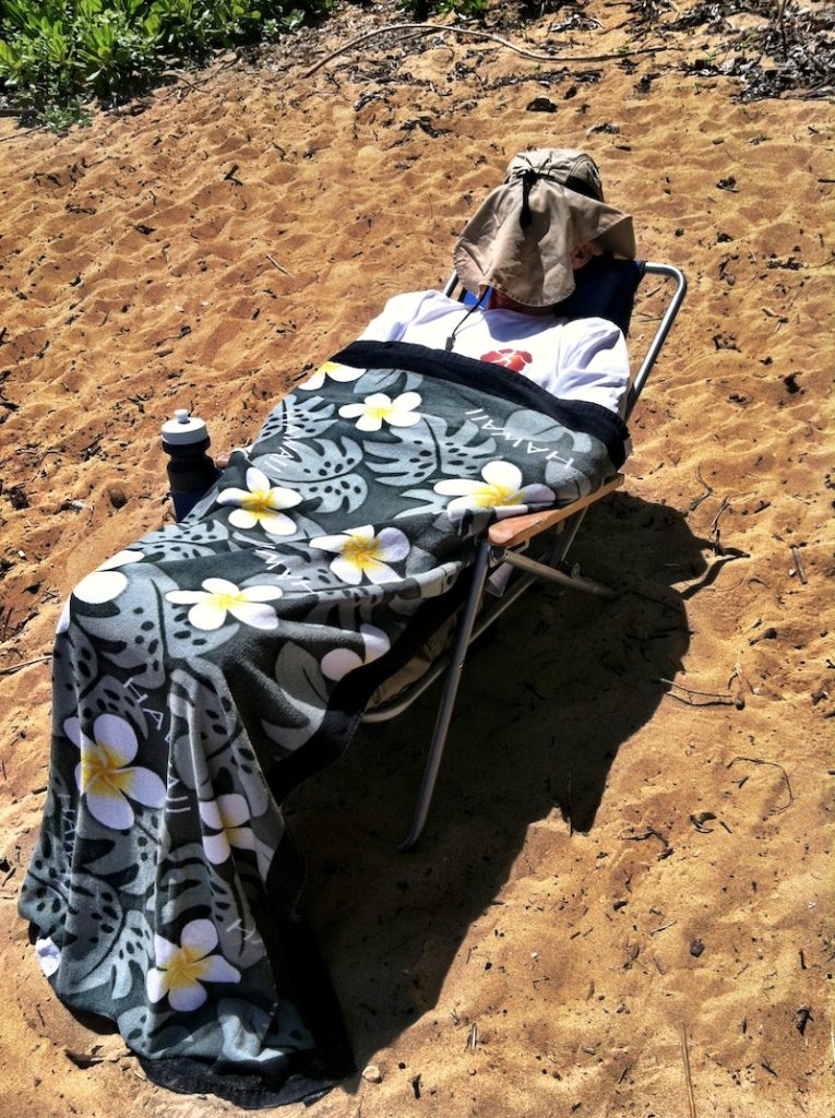 Man on beach unaware of safe travels