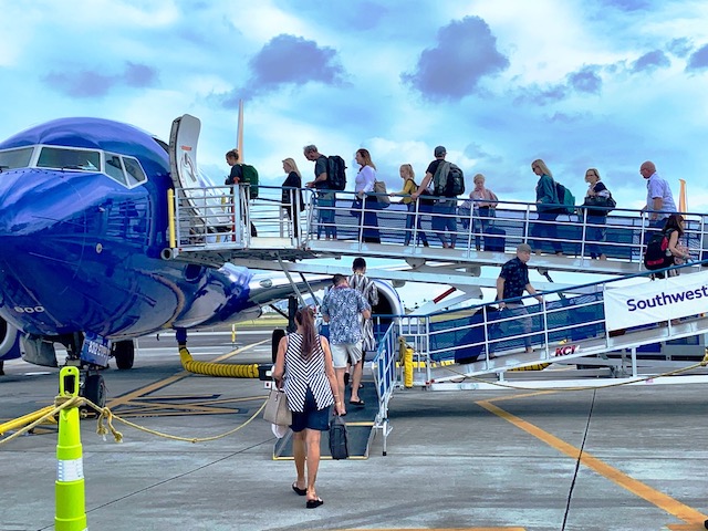 Travel is a great gift. People getting onto an airplane.