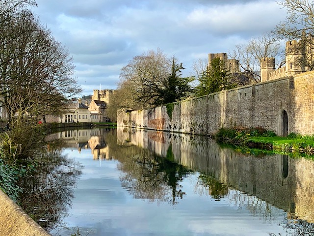 Beautiful reflections in the moat around the Bishop's Palace in Wells, Somerset