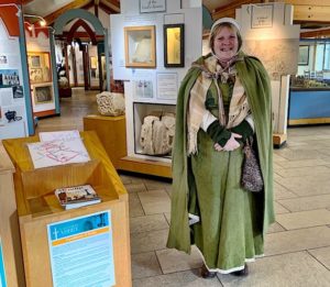 Abbey employee in period garb and the Glastonbury abbey