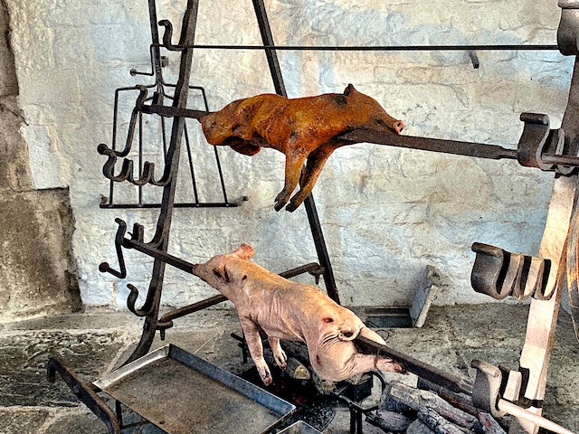 Pigs on the spit in the Abbots Kitchen at Glastonbury Abbey seen during our day trip to Glastonbury.