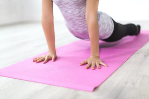 Woman exercise at home since she can't travel.