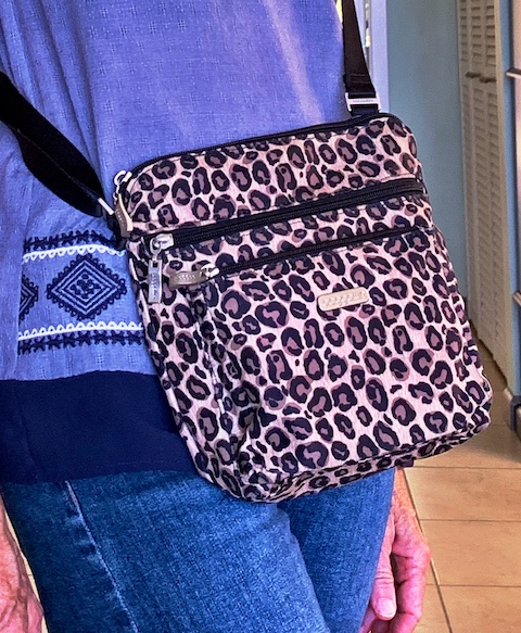 Lady wearing a crossbody travel bag for traveling.