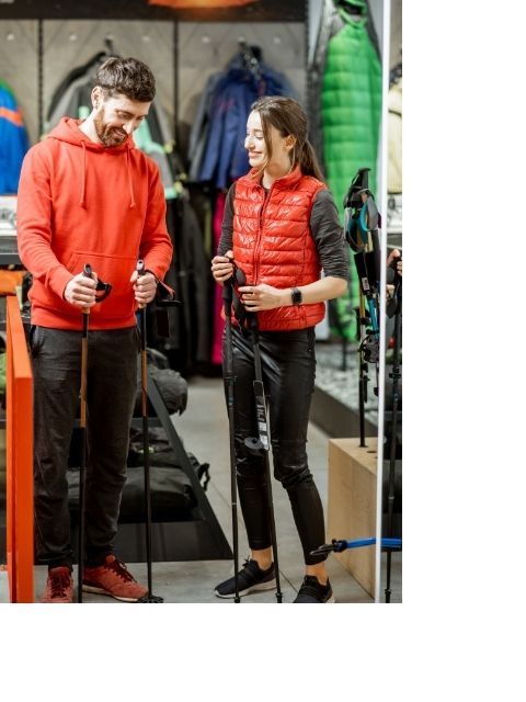 A couple buying hiking poles as a gift