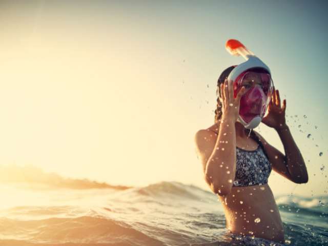 Girl in full face snorkel mask