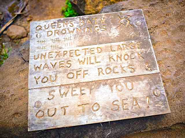 Sign by Queens Bath warning of dangers to your Kauai Vacation