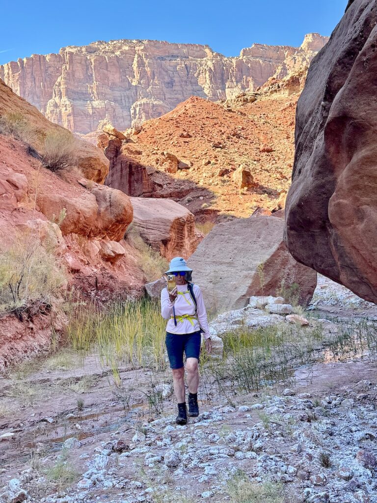 Woman hiking in a rocky aea that is one of the trails in Marble Canyon AZ