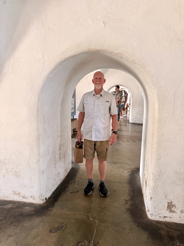 Man standing in the archaway of Castillo San Felipe Del Morro in San Juan, Puerto Ricl